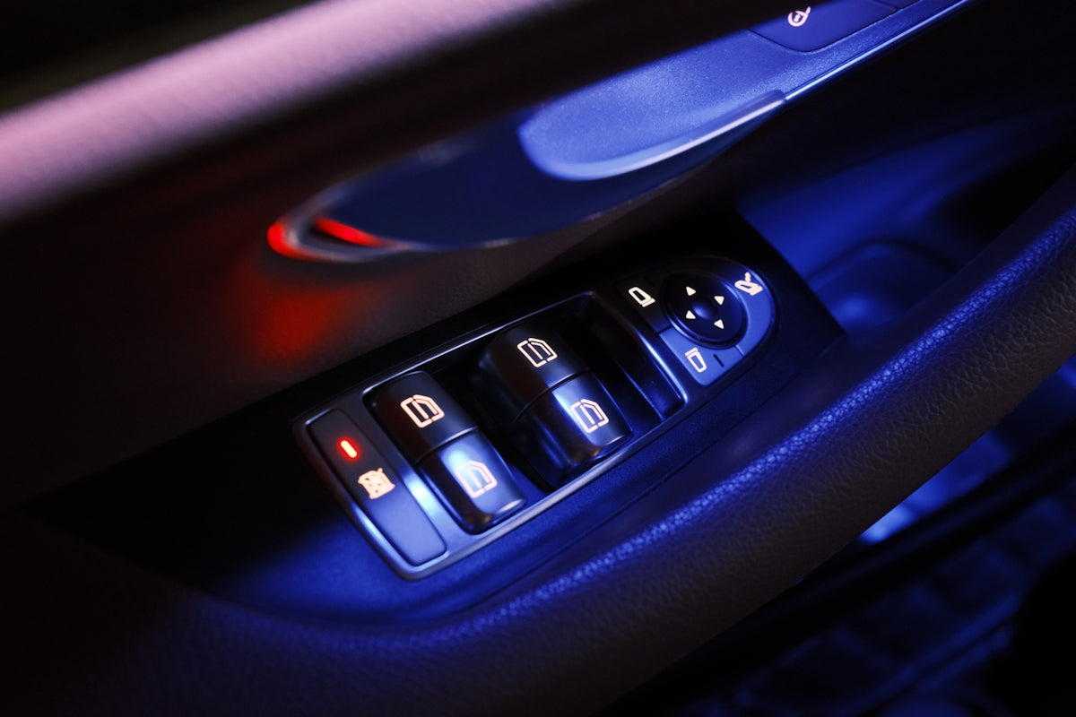 Car door's window and lock controls are glowing.